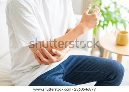 man with elbow pain White