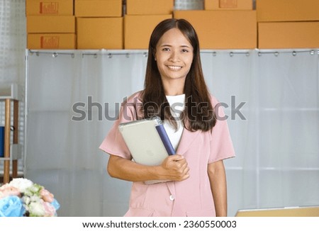 Business woman takes product promotional photos in a photo studio.