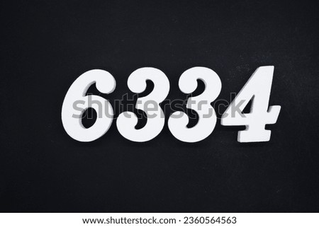 Black for the background. The number 6334 is made of white painted wood.