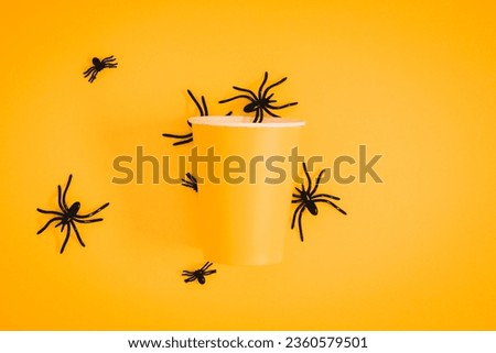 Halloween decorations concept. Halloween with spiders on orange background. Flat lay, top view, copy space