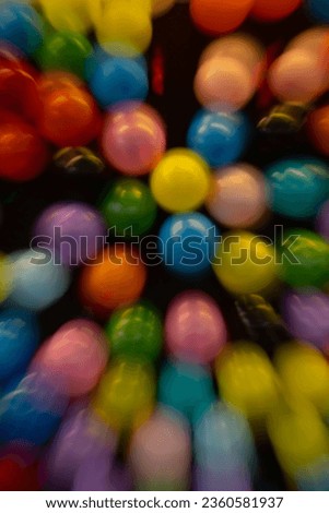 vertical abstract motion blur background of colored balloons at fair special movement effect created by long time exposure shutter speed and in camera movement fun celebratory party birthday backdrop 