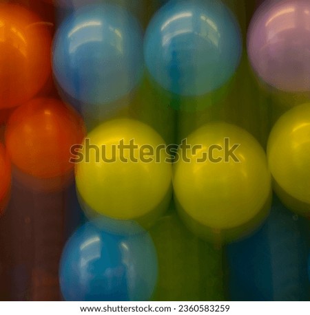 abstract motion blur background of colored balloons at fair special movement effect created by long time exposure shutter speed and in camera movement fun celebratory happy birthday party backdrop 