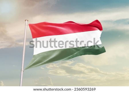 Hungary national flag waving in beautiful sky.