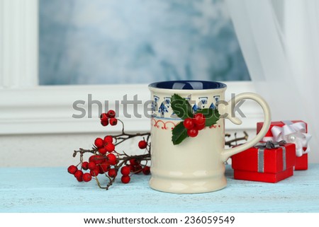 Christmas composition with cup of hot drink, on wooden table