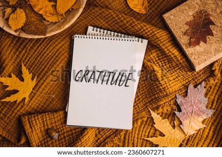 How to Practice Gratitude. Writing Autumn fall gratitude journal. Open paper notebook pages with Text gratitude and fall leaves brown bed. Notice appreciate good things, Express gratitude to yourself. Royalty-Free Stock Photo #2360607271