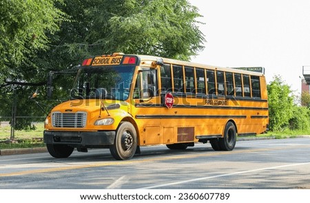 orange school bus symbolizes new beginnings and excitement for a fresh school year in autumn Royalty-Free Stock Photo #2360607789