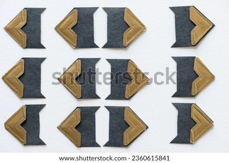 fancy paper photo corners with gold accents arranged with tip pointing left and right on blank paper