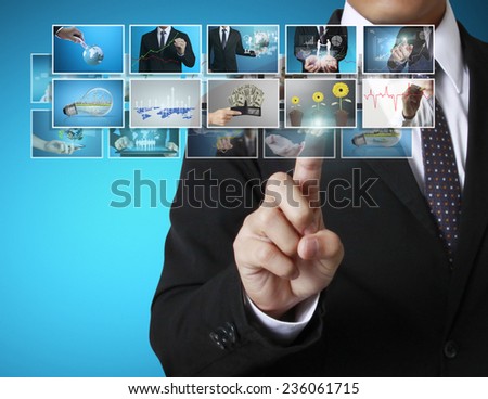 Businessman touch screen to choose digital photos