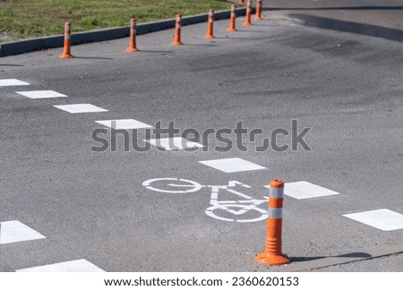 The road sign of the bike path. Drawing of bicycle with white paint on the asphalt. Marking bikeway on the pavement. Information symbol of bike road. City ecological transport. Active lifestyle.