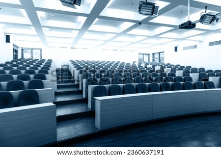 Empty college lecture hall with row of chairs Royalty-Free Stock Photo #2360637191