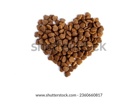 The heart is made of dry cat food. Love to the animals. Care. Royalty-Free Stock Photo #2360660817