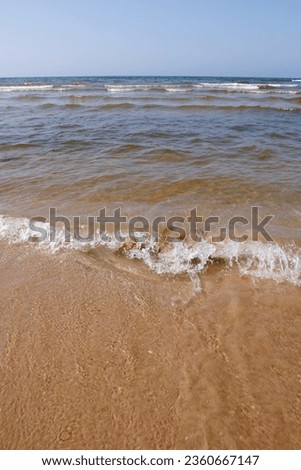 Rocks and sand on a serene beach at Lake Ontario