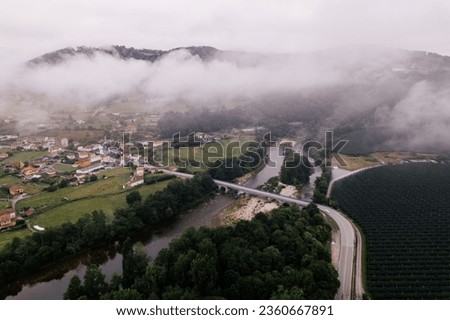 AERIAL DRONE PHOTO OF SMALL VILLAGES IN THE NATURE WITH RIVERS AND BRIDGES