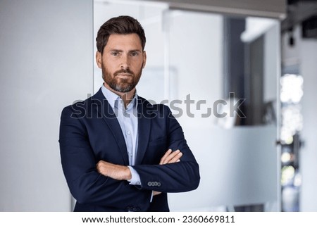 Portrait of mature experienced financier businessman, man thinking seriously looking at camera with crossed arms, confident investor banker inside office workplace in business suit. Royalty-Free Stock Photo #2360669811
