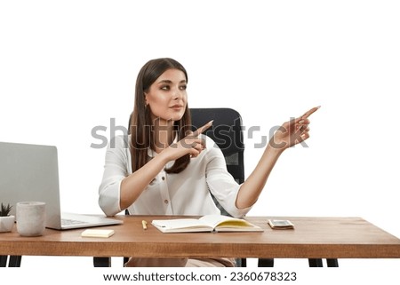 woman using laptop and pointing at copy space