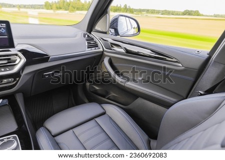 Beautiful view of interior of front leather seats of car while driving on highway. Sweden.