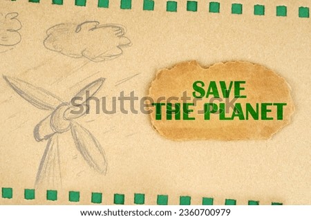 A wind generator and clouds are drawn on cardboard with green holes, next to it lies a cardboard with the inscription - Save The Planet. Ecological concept.