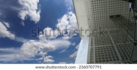 La Grande Arche (against the background of sky with clouds). La Defense, commercial and business center of Paris, France 