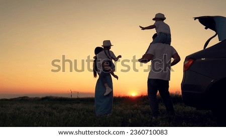 Dad with child, daughter on his shoulders, mom, children dance and admire beautiful sunset. Parents and children stopped at campsite by car. Happy family travels by car. Big family, Travel by car. Kid Royalty-Free Stock Photo #2360710083
