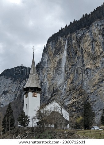 Famous postcard picture of Lauterbrunnen church and Staubbachfall waterfall