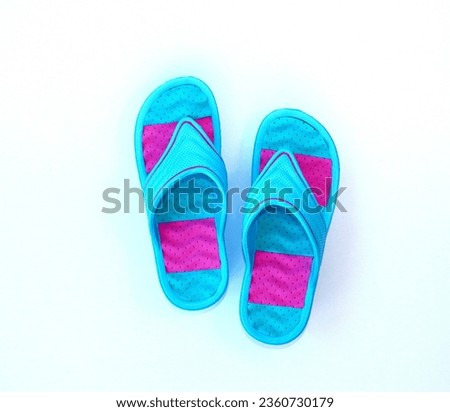 Colored bright flip flops isolated on a white background, top view.