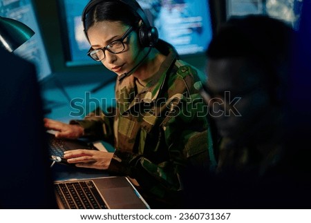 Military control room team, headset and woman with computer and tech for communication. Security, global surveillance info and soldier thinking in army office at government cyber data command center. Royalty-Free Stock Photo #2360731367