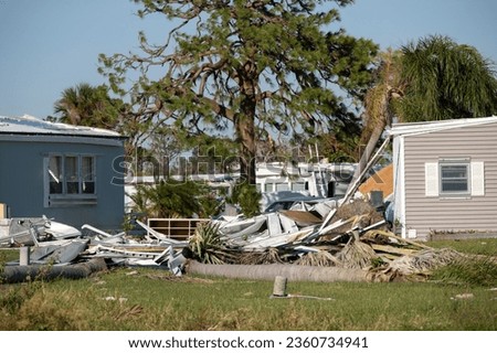 Severely damaged houses after hurricane Ian in Florida mobile home residential area. Consequences of natural disaster Royalty-Free Stock Photo #2360734941