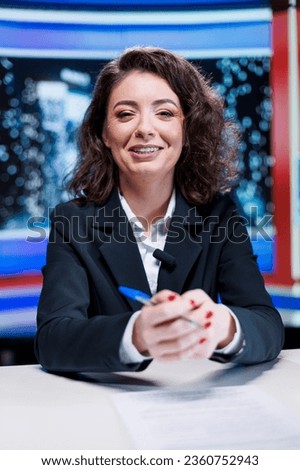 Journalist going live on night show in newsroom, discussing about latest incidents or daily scandals between celebrities. Presenter working on entertainment and media segment, cover newscast. Royalty-Free Stock Photo #2360752943