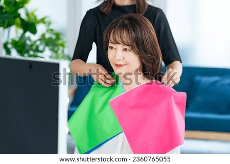 Middle-aged Asian woman doing personal color diagnosis. Beauty advisor. Royalty-Free Stock Photo #2360765055
