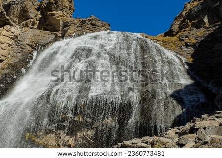 Girl's braids waterfall near Mt. Elbrus in summer sunny day. Prielbrusie national park, Kabardino-Balkaria, Russia. Horizontal close up image