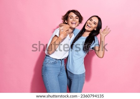 Photo of laughing good mood comic good mood girls lesbians love their relationship carefree hugs isolated on pastel pink color background