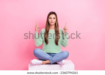 Full body photo of young lady sit podium select more websites page best offers mockup fingers direct up isolated on pink color background