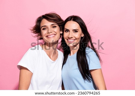 Closeup portrait of optimistic young girls smiling cheerful good mood best friends album memories photo isolated on pink color background