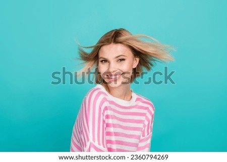Portrait of nice young woman wear striped trendy pullover posing toothy smile lightness blonde hair isolated on aquamarine color background