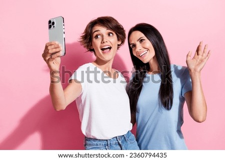 Photo of two best friends girls have fun together selfie shoot iphone weekend party shopping day isolated on pastel pink color background