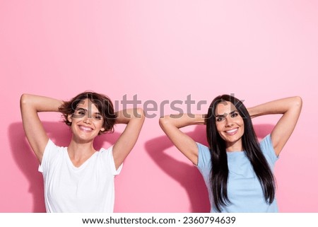 Photo of two relaxed chill girls hands head take nap comfortable dreaming sleepy lesbians shopping isolated on pink color background