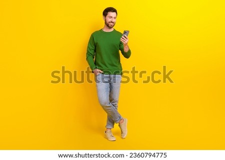 Full body photo of funny professional smm manager content maker blogger young guy hold apple iphone isolated on yellow color background