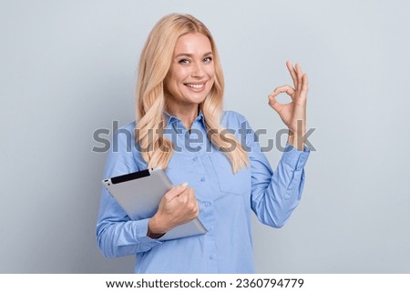 Photo of attractive elegant recruiter toothy smile hold tablet demonstrate okey symbol isolated on grey color background
