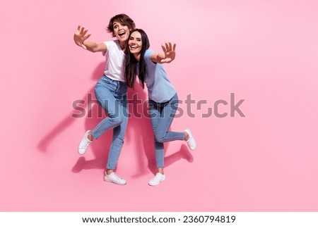 Full length body photo of two young ladies welcome crazy greetings invite black friday shopping mall isolated on pink color background