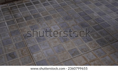 photo of a dirty and dull bathroom floor that needs to be cleaned