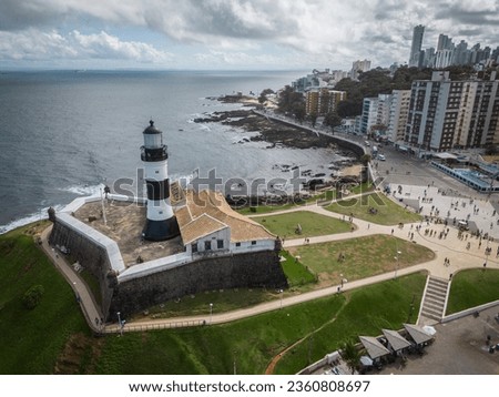 Beautiful aerial view to historic lighthouse and fort by the ocean in Salvador, capital city of Bahia State, Brazil