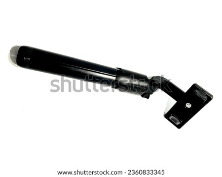 Black mini tripods made of metal. Photo taken at close range with a white background