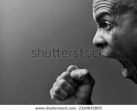 mental health man shouting with anger on grey background with people stock photo 