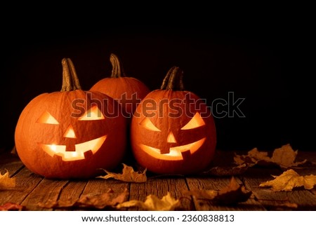 Halloween pumpkins on wooden table with copy space