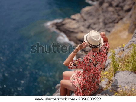 Nice Happy Female Enjoying Sunny Day on Greek Islands. Travel to Greece, Mediterranean islands outside tourist season. Enjoying life and looking at the sea. Turquoise sea background.