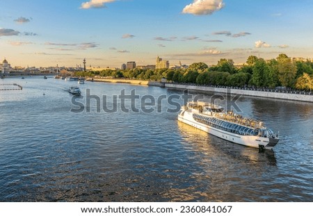Cruise ship sails on the Moscow river in Moscow city center, popular place for walking. Panoramic view of Moscow river with cruise boat Royalty-Free Stock Photo #2360841067