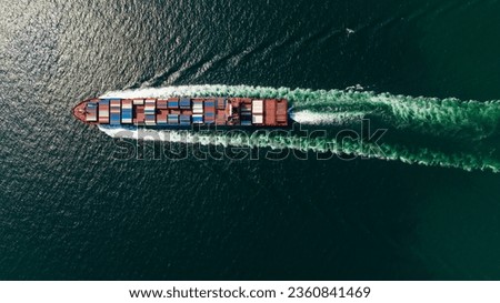 cargo container ship sailing full speed in green sea to import export goods and distributing products to dealer and consumers worldwide, by container ship Transport, business logistic delivery service