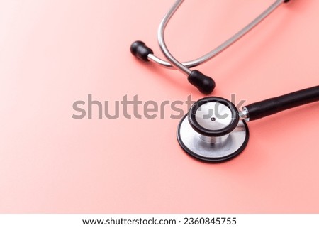 Stethoscope on a pink background.