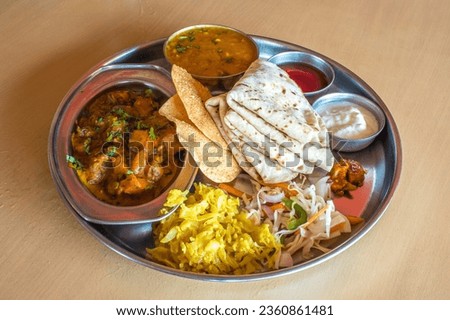 Shot of healthy and tasty Indian vegetarian Lunch dinner platter with many variety of appetising vegetarian dishes to tangle your taste buds and give you a complete meal satisfaction Royalty-Free Stock Photo #2360861481