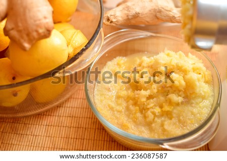 closeup picture of food making concept & organic healthy ingredients as lemon & ginger in glass bowls.